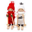 The 5" tall Scandinavian Girl on Skis figurine features a handcrafted wooden design with a red knit outfit, ski poles, and wooden skis—a charming Nordic decoration for any space.