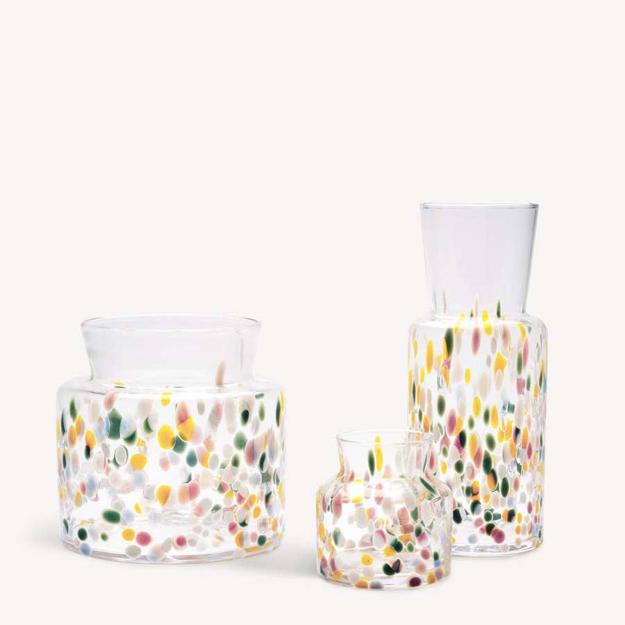 Three clear glass Meadow vases with multicolored, confetti-like spots of varying sizes and shapes.