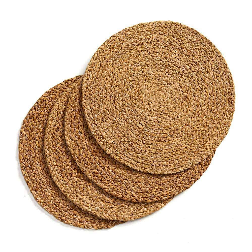 Four Natural Braided Woven Placemats, skillfully handcrafted and arranged in a slightly fanned-out stack.