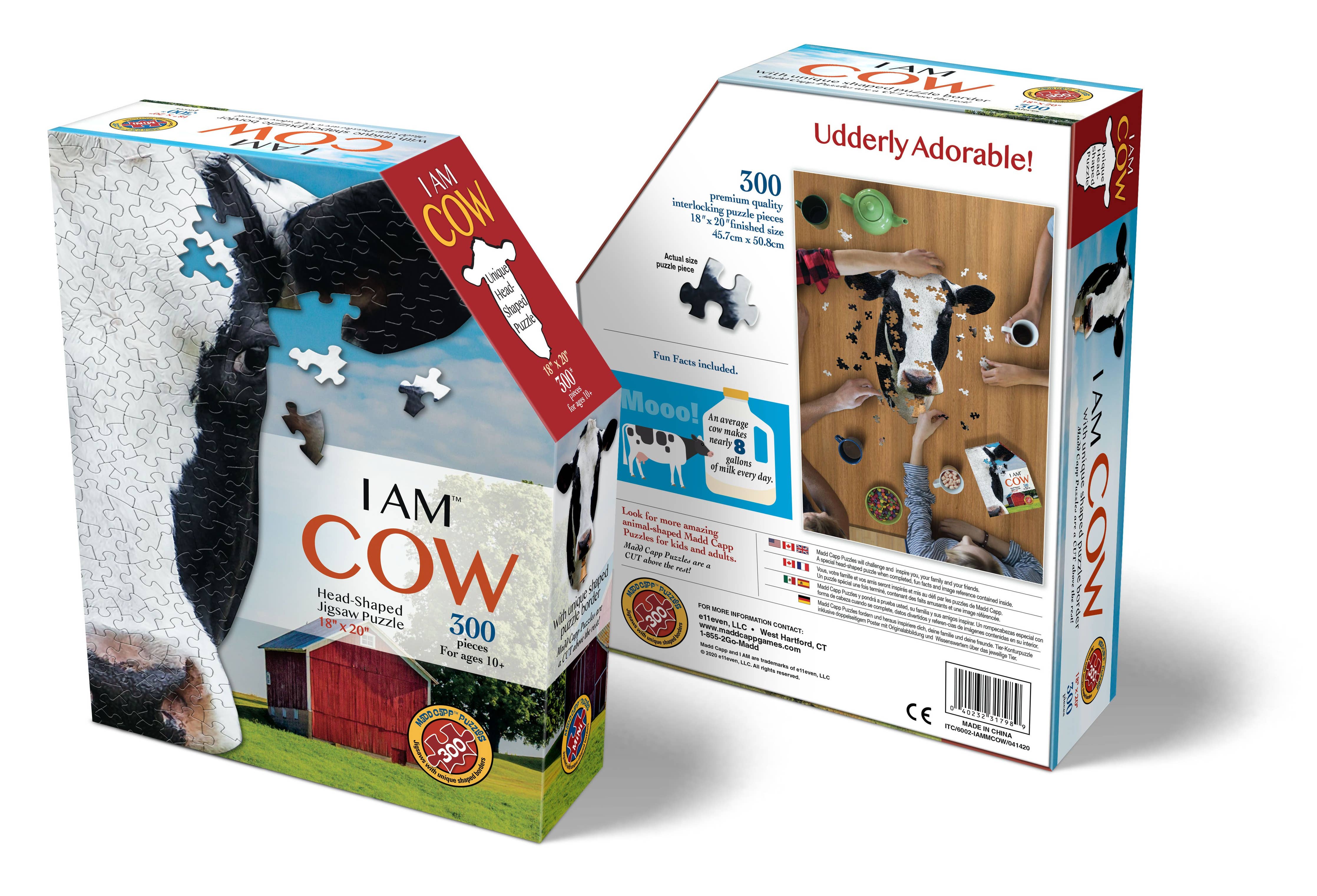 Two boxes of the I AM Cow 300-piece puzzle, depicting a cow set in a pastoral scene and crafted from premium quality chipboard. This unique-shaped jigsaw puzzle also features educational Fun Facts on the back.