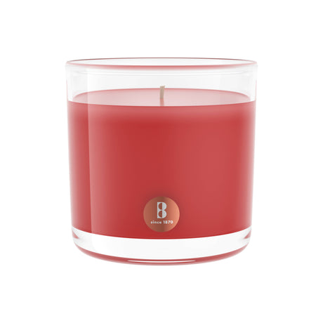 A Pomegranate Scented Candle, measuring 3.75 x 3.75 inches and offering up to 43 hours of burn time, comes in a clear glass holder with a red hue and is enriched with high-quality natural extracts. The candle features a label indicating "since 1870.