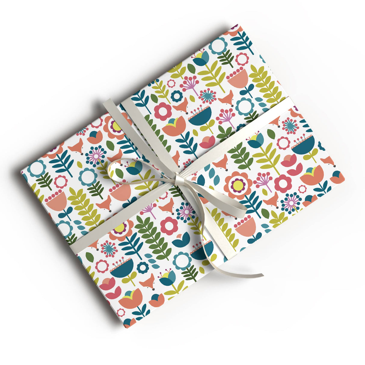 Two rectangular gifts wrapped in Juniper Blue's Scandinavian Floral Folk Art "Tuli" Gift Wrap (glossy, 2 sheets, 20"x29" each), tied with white satin ribbon bows, displayed on a white background.