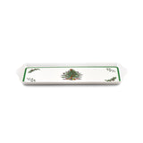 Rectangular melamine tray with green border, Christmas tree illustration in the center, holly accents in the corners, and two side handles.