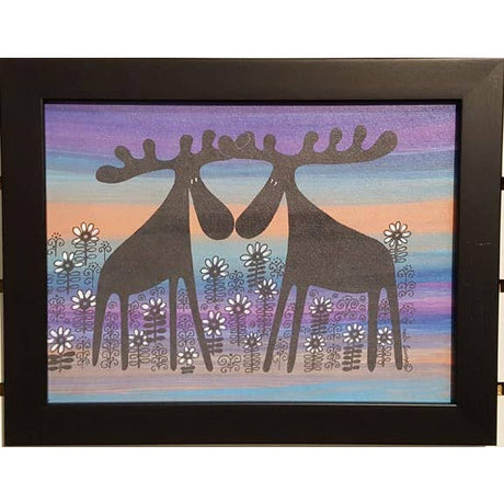 The framed 11x14 artwork, Moose Couple, Alfred & Anna in a Flower Bed Orange, features two stylized moose among white and purple flowers with a striped purple, blue, and orange background—ideal for Scandinavian decor.