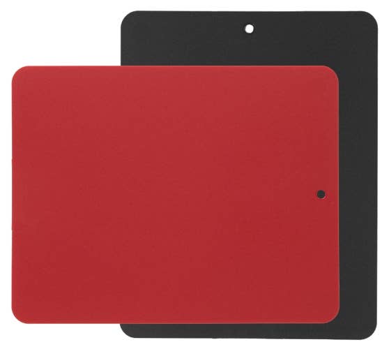 Two flexible cutting boards, one red and one black, with rounded corners and a small hole near the edge, stacked on top of each other.