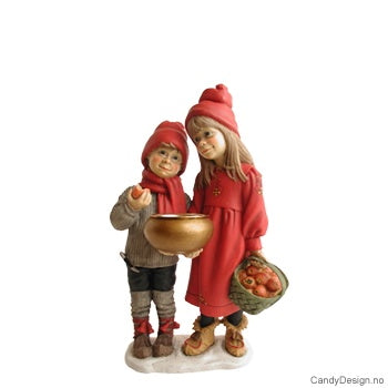 A delightful porcelain figurine titled "Figurine: Britta (Apple Girl) & Her Brother by Carl Larsson," showcasing two children dressed in winter clothing. One child is holding an apple and a basket, while the other carries an apple and a bowl.