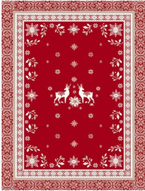 Red rectangular cotton tea towel featuring two white reindeer in the center, surrounded by snowflakes, floral motifs, and geometric borders in a Scandinavian-inspired pattern.