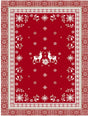 Red rectangular cotton tea towel featuring two white reindeer in the center, surrounded by snowflakes, floral motifs, and geometric borders in a Scandinavian-inspired pattern.
