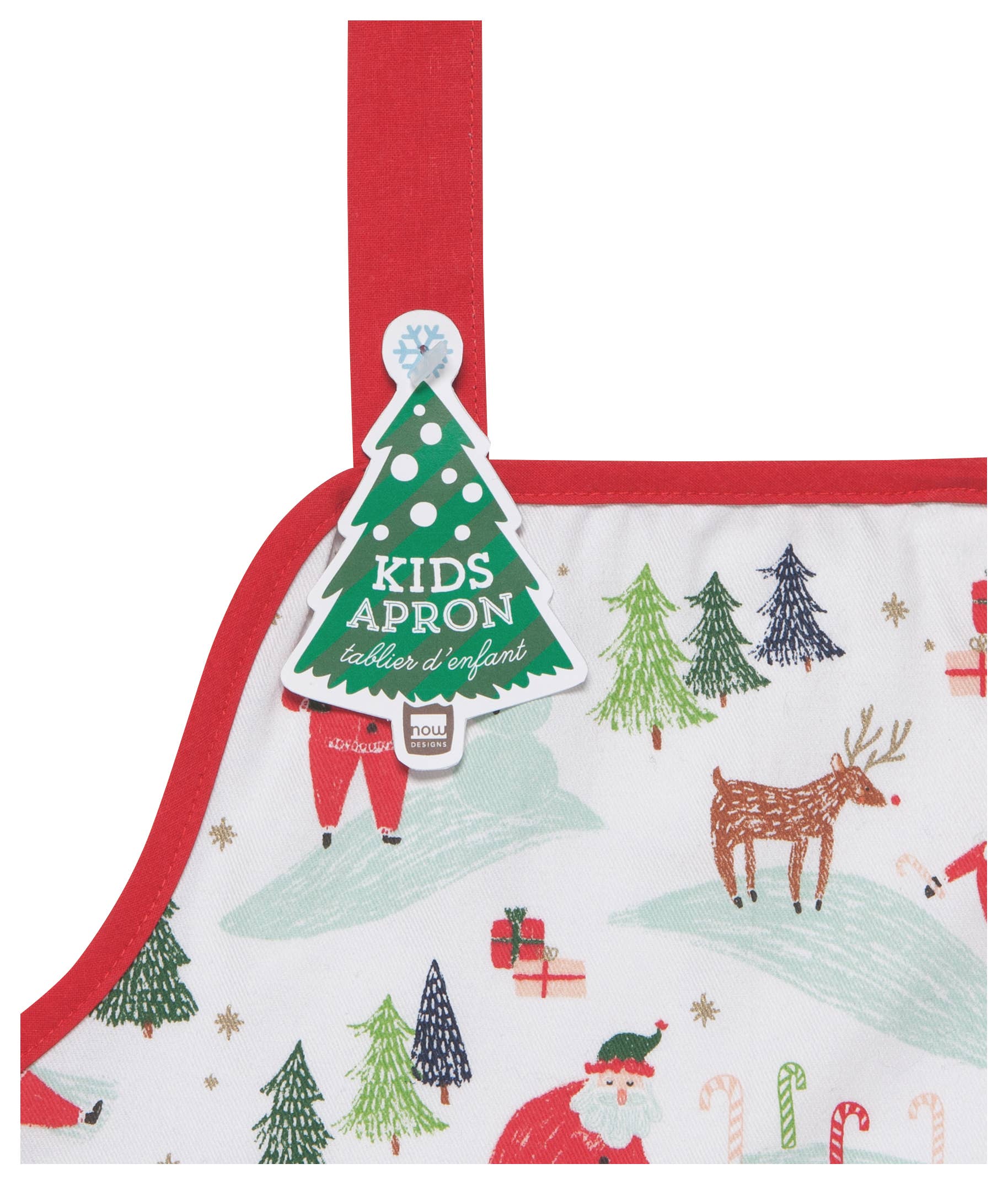 Close-up of the Must Be Santa Kids Apron showcasing festive designs of Santa, reindeer, Christmas trees, and presents. Ideal for holiday baking, this white apron with red trim features a playful green tree-shaped tag.