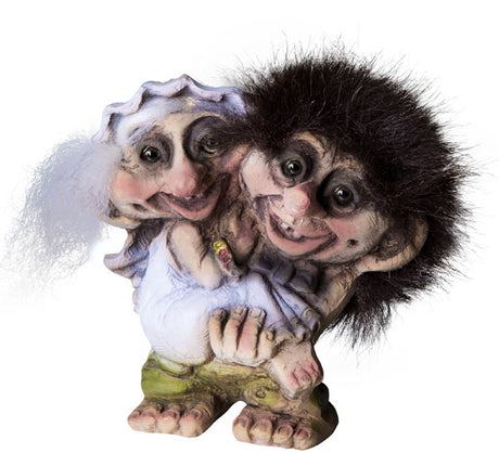 NyForm Troll Wedding Couple Figurines, 4 tall—handmade in Norway. Features a smiling pair with large eyes; one with wild dark hair, the other with white hair and a bonnet. A charming collector’s item for troll enthusiasts.