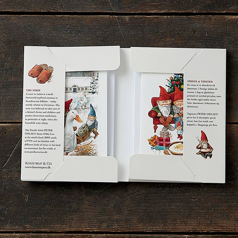 Box with two nisse cards showing Christmas scenes, geese, and Nordic gnome figures; printed descriptions in English and Danish appear on the box flaps.