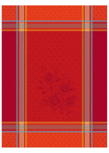 The Bouquet Red Tea Towel is a 20"x28" woven cotton tea towel with red and orange plaid, gray and yellow stripes, and a subtle central floral motif inspired by Provençal design, made using traditional jacquard weaving.