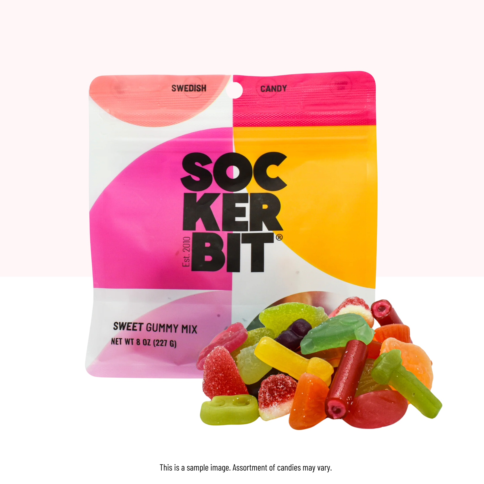 An 8oz bag labeled "Candy: Sweet Mix Swedish Gummy Candy" stands behind a pile of assorted non-GMO Swedish gummy treats, all displayed on a white surface.