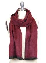 A mannequin showcases the Alpaca Scarf in Sapphire Red with Black Fringe, draped loosely for a soft, unisex look.