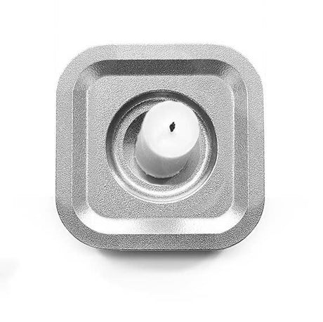 A white singel candle sits in the Stumpastaken Ettan candle holder, crafted from 100% recycled aluminum with a white powdercoated finish, measuring 8.8x8.8x4 cm, shown on a white background.