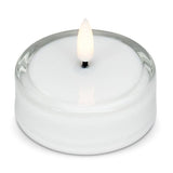 White LED tea light inside a clear glass holder with a flickering flame.