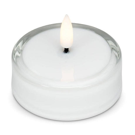 White LED tea light inside a clear glass holder with a flickering flame.