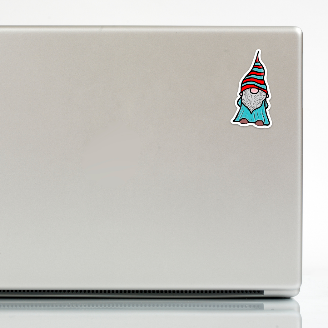 A silver laptop features a small, hand-drawn Sticker: Gnome III - Sticker in the top right corner of the lid.