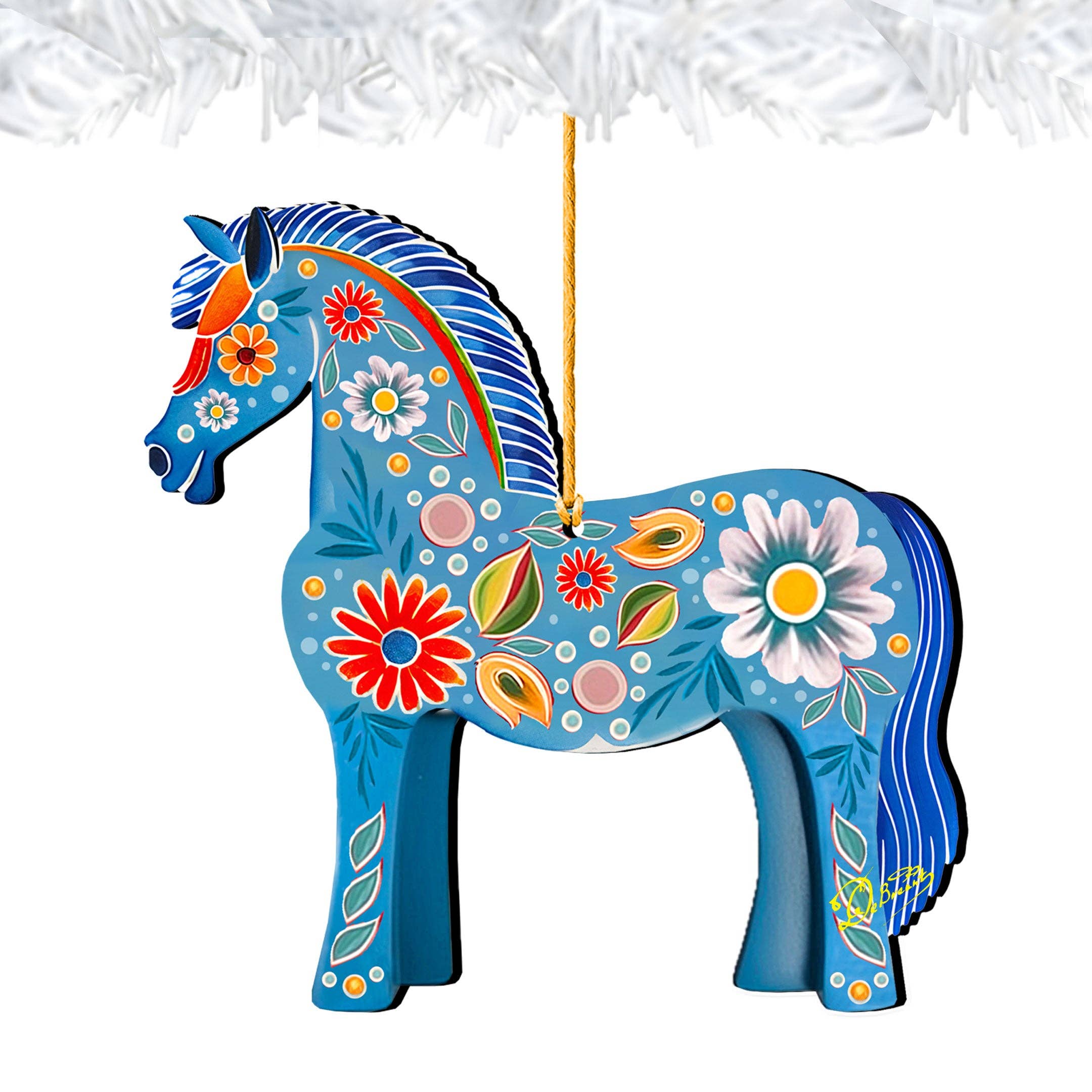 This beautifully crafted Ornament: Danish Horse Decorative Wood Ornaments GDebrekht Love Family showcases a blue horse embellished with vibrant floral patterns, suspended gracefully by a string against a white background. Reminiscent of G.DeBrekht Art's iconic designs, it brings an element of charm and tradition to any space.