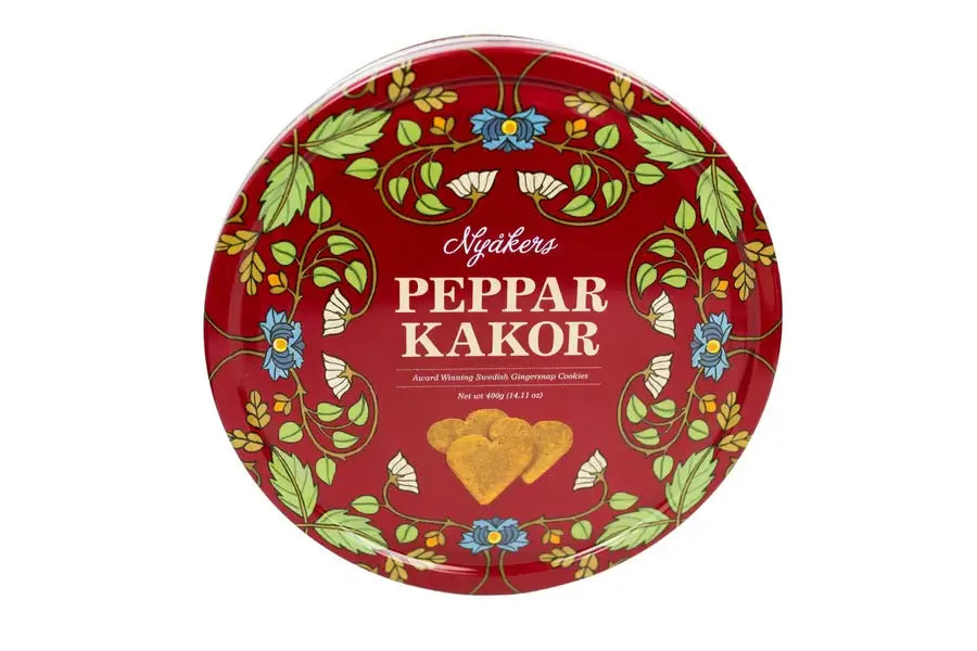 Red tin of Nyakers Original Heart-Shaped Gingersnaps 14.11oz with a floral design and heart-shaped ginger cookies on the label.