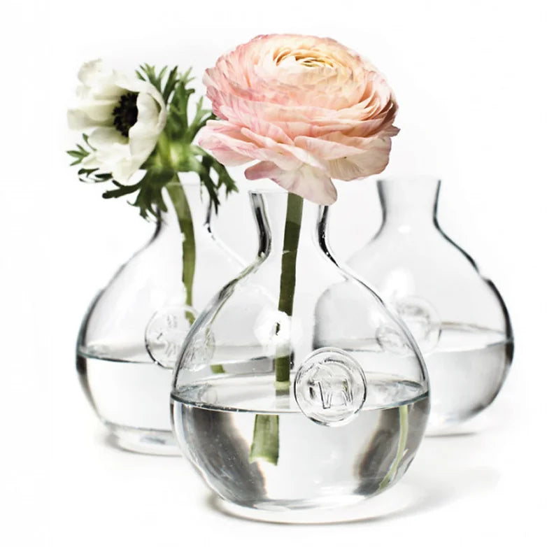 Crafted in Portugal, three mouth-blown vases each cradle a single bloom—a pink rose and a white flower—arranged elegantly, capturing the classic beauty reminiscent of the Vase: Anna Viktoria Glass Dala Horse Vase.