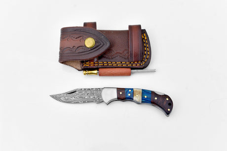 The Damascus Steel Pocket Knife features a patterned blade and multicolored handle, displayed below a brown leather sheath with decorative stitching and an included sharpening rod.