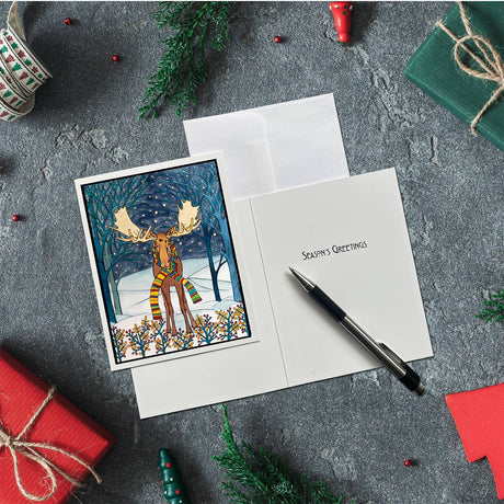 The Card Pack: Holiday Moose Packaged Christmas Cards (8 cards & envelopes) features “Season’s Greetings” with festive decorations—ideal for fans of Sarah Angst Art Greeting Cards.