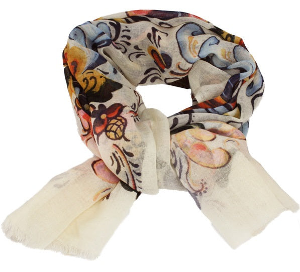 The Norge White Multi Color Rosemaling Scarf, crafted from 100% wool, features a floral pattern that captures the essence of traditional Norwegian Rosemaling and is light, sheer, and neatly folded.