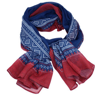 The Scarf: Marius Blue & Red Scandinavian Design Scarf features a blue and red color scheme with white geometric patterns inspired by classic Norwegian design.