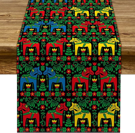 A wooden table with a 72" Swedish Dala Horse Black Table Runner featuring multicolor horses and folk art kurbits flowers.