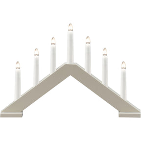The Konstsmide 7-Light Electric Candelabra in a matte beige wood finish features seven lights in a row—ideal for bringing classic Scandinavian holiday style to your home.