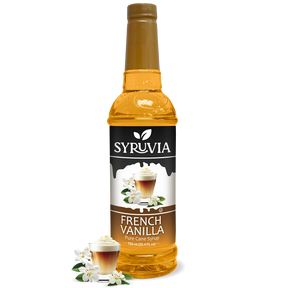 A bottle of Syruvia French Vanilla Coffee Syrup with real cane sugar, gluten-free, features a label with a coffee drink and vanilla flowers plus extra vanilla flowers at the base.