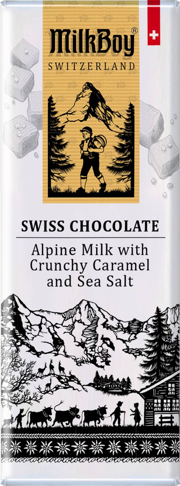 The packaging for MilkBoy Milk Chocolate with Caramel & Sea Salt Snack Size Bars 1.4 oz emphasizes the indulgent flavor of Alpine Milk Chocolate combined with crunchy caramel and sea salt. It features illustrations of a mountain scene with a boy and animals, and the Swiss flag prominently displayed in the top right corner.