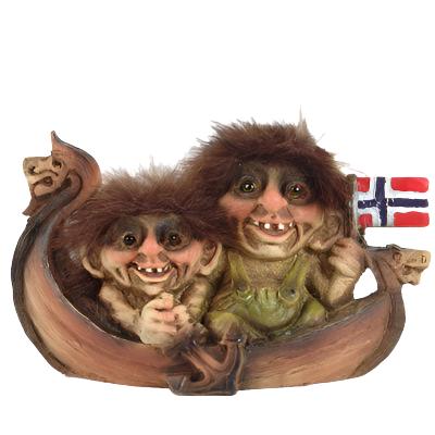 Two whimsical NyForm Troll figurines with furry hair are seated in a Viking ship, proudly holding a Norwegian flag.