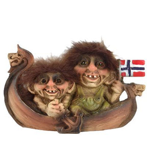 Two whimsical NyForm Troll figurines with furry hair are seated in a Viking ship, proudly holding a Norwegian flag.