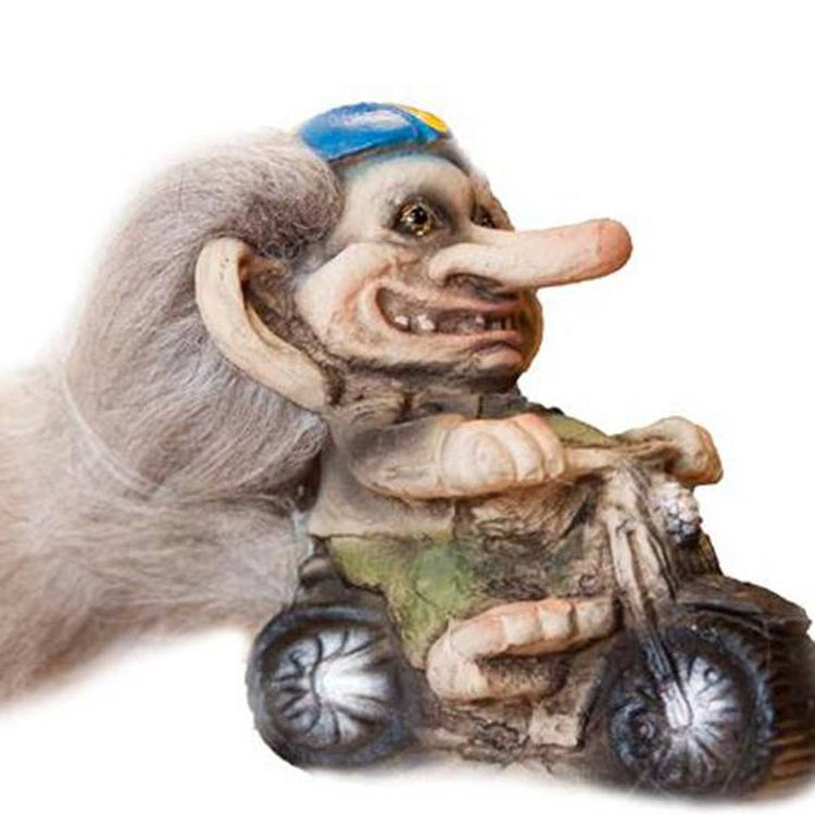 The NyForm Troll on Motorcycle figurine features a whimsical troll with a long nose and gray hair, riding a small motorcycle and wearing a blue helmet. This delightful piece embodies classic Norwegian design, perfect for collectors.