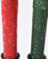 Close-up of Diamond Dusted Christmas LED Timer Taper Candles in red and green, featuring coarse salt crystals on their surfaces.