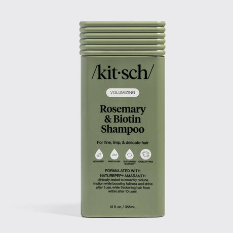 Olive green bottle of Kitsch Hair: Volumizing Rosemary & Biotin Shampoo 12oz for fine, limp, and delicate hair, featuring nourishing biotin and rosemary with certification icons and product details on the front label.