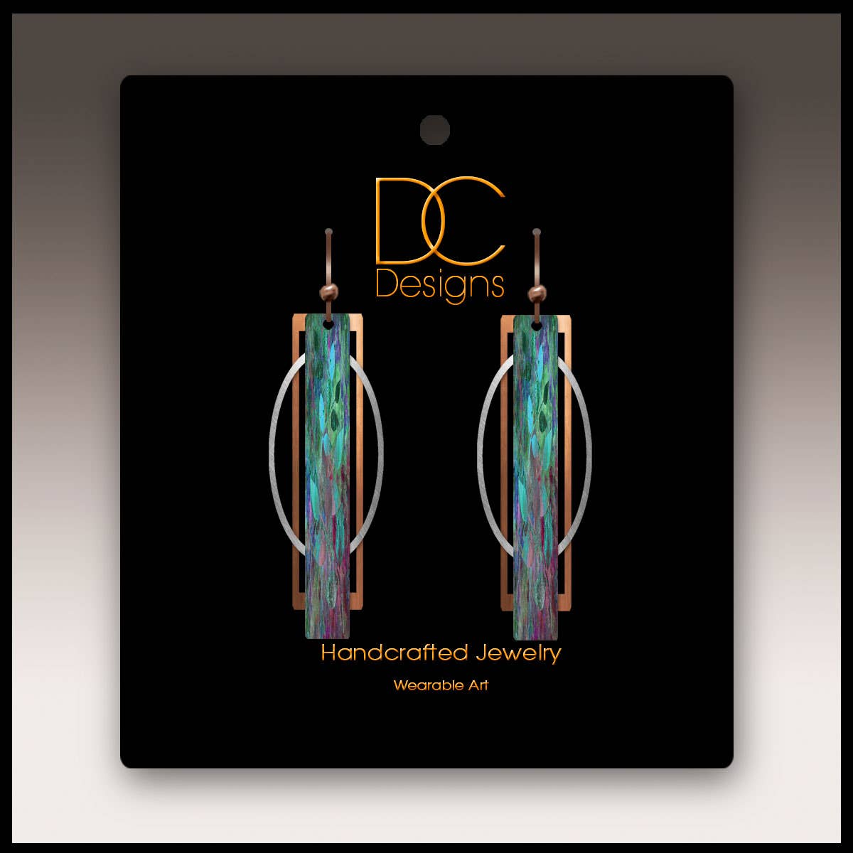 Earrings: Teal Purple Geometric Multilayer Metal Accent Handmade Earrings. Features multicolored rectangular design, oval metal hoops, and hypoallergenic materials. Displayed on black DC Designs jewelry packaging.