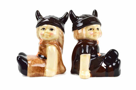 The Shakers: Viking Couple Vintage Salt & Pepper Shakers (3" Tall) feature a brown and black ceramic Viking duo with horned helmets, yellow hair, and cheerful smiles—perfect for adding fun Scandinavian charm to your kitchen.