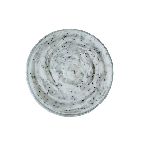 A top view of Bath Scrubs: Sugar Scrubs - Sandalwood & Vanilla shows a round container of white cream with small black exfoliating particles, offering gentle exfoliation for radiant skin against a white background.