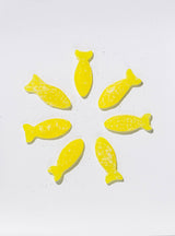 Seven yellow fish-shaped BonBon Sour Elderflower Fish (150g) candies are arranged in a circle on a white background, highlighting this tasty vegan and gluten-free Swedish treat.