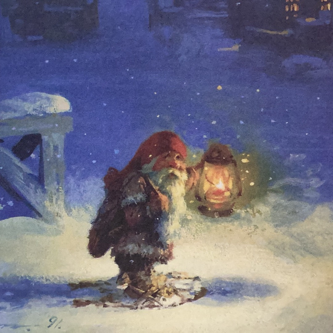 A petite tomte in a red hat clutches a glowing lantern while snow gently descends around him as he stands on a snowy path at night, making it an ideal design for the Christmas cards by Svein Solem featured in the "Cards: Christmas Cards Svein Solem 4 Designs 8 Cards & Envelopes" set.