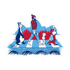 The "Sticker: MN Abbey Road by Adam Turman" features four cartoon characters strolling across a crosswalk in a stylized cityscape illustration, capturing the essence of Minnesota pride with subtle hints of iconic Minnesota landmarks in the background.