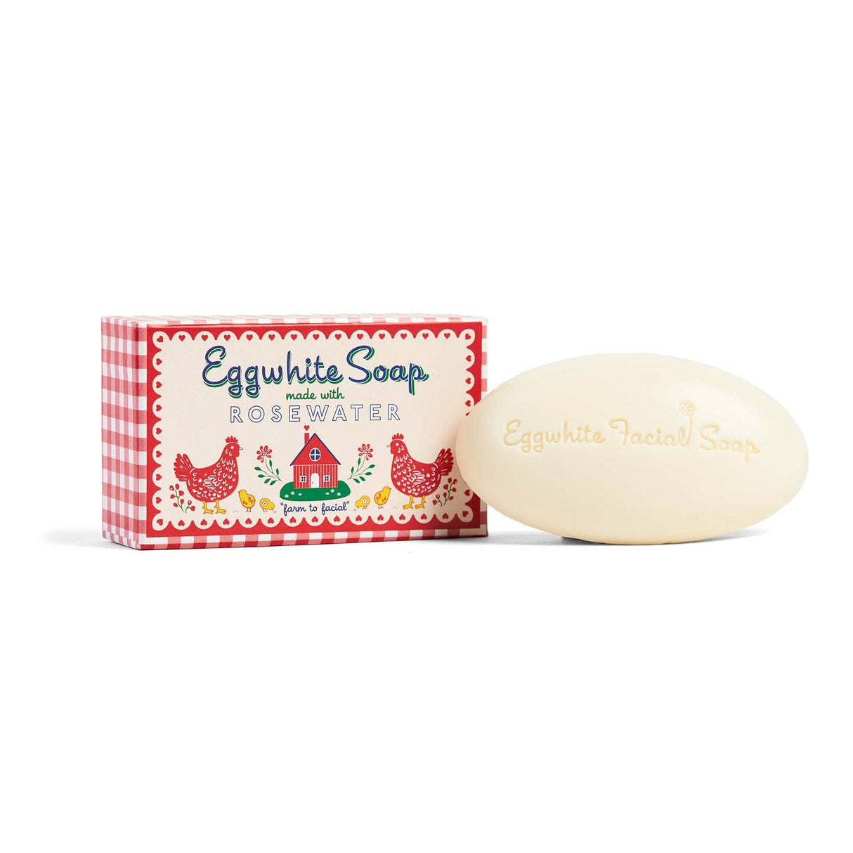 A bar of Soap: Eggwhite & Rosewater Facial Soap 1.76oz, famed for its radiant glow, is displayed beside its vibrant box decorated with chickens, a barn, and red checkered sides.