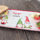 Melamine tray with gnome illustrations, sandwiches, cheese skewers, a strawberry, and the text “Gnome for the Holidays,” displayed on a wooden table.