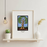 Artwork: Together Forever Tree by Sarah Angst, 8"x10" or 11"x14" giclee print, displayed on a shelf with a potted cactus, white vase with dried grass, and a hanging light bulb.