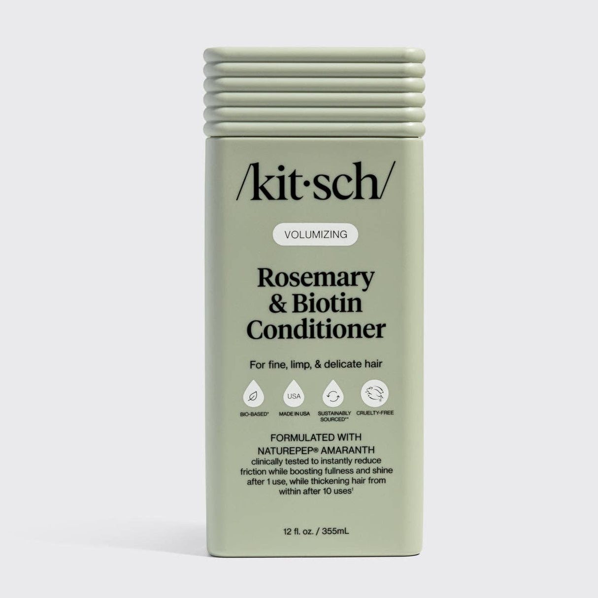A green rectangular bottle of Hair: Volumizing Rosemary & Biotin Conditioner 12 fl oz, designed for fine, limp, and delicate hair. Enriched with rosemary and biotin to help thicken hair.