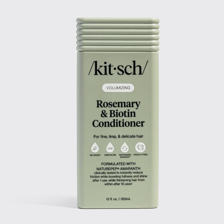 A green rectangular bottle of Hair: Volumizing Rosemary & Biotin Conditioner 12 fl oz, designed for fine, limp, and delicate hair. Enriched with rosemary and biotin to help thicken hair.
