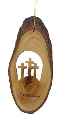 The Ornament: Bark Slice with Three Crosses - 4 to 6" is beautifully crafted from olive wood and features three carved crosses on a hill, inscribed with Jerusalem.